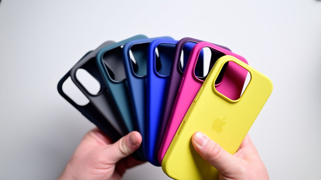 Five stylish iPhone cases displayed on a desk with a coffee cup, plant, and laptop, showcasing various designs and textures for style and protection.