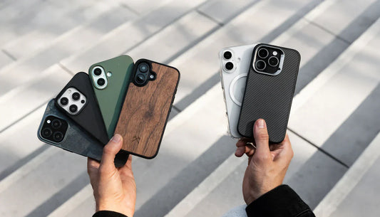 A lineup of iPhones showcasing protective cases in various colors and styles, including black, wood, navy, yellow, and red, on a wooden surface.