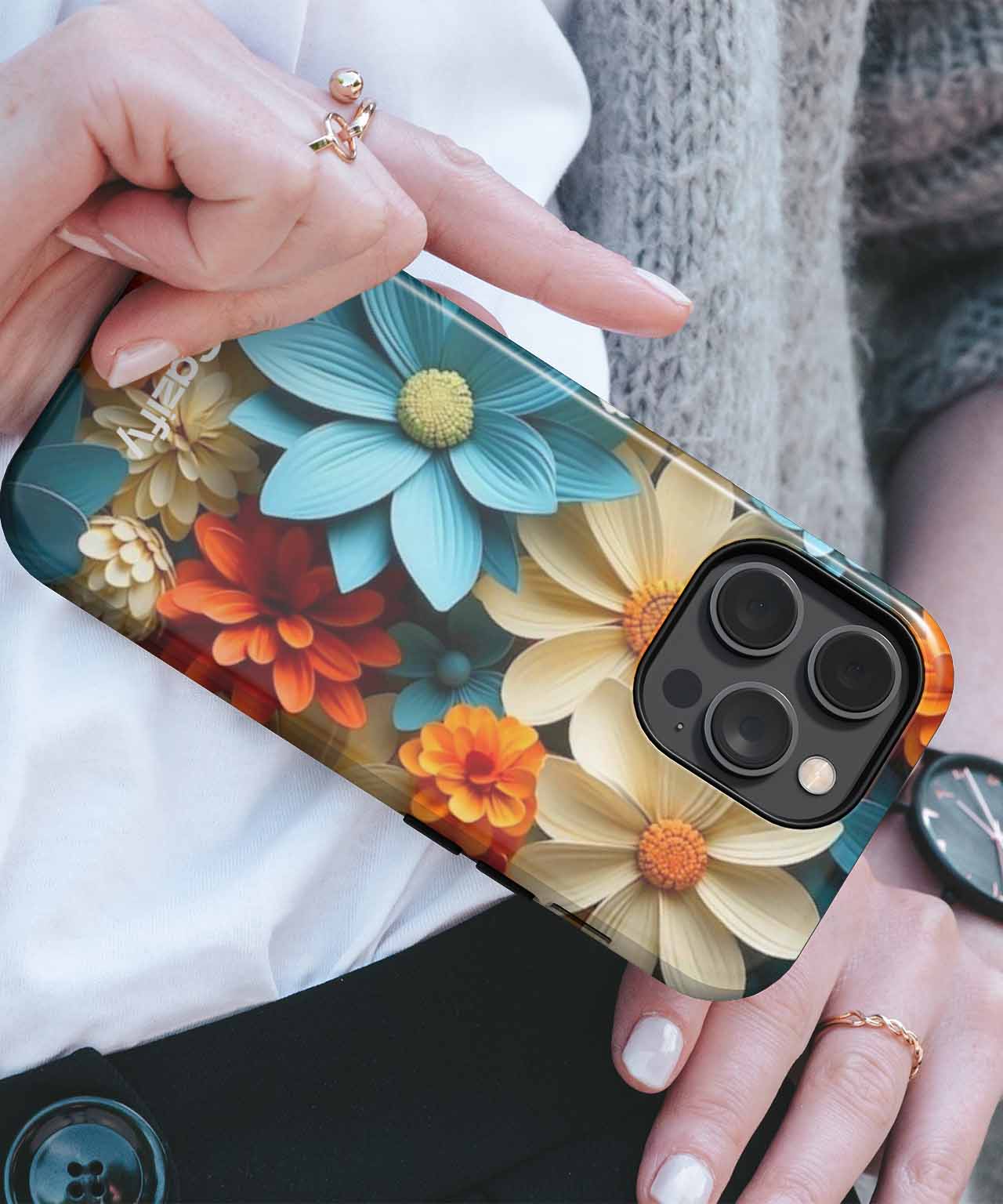 Colorful floral design iPhone case on a black iPhone with triple camera lens. - Blooming Colorful Delightful Garden iPhone case - Cazify Canada