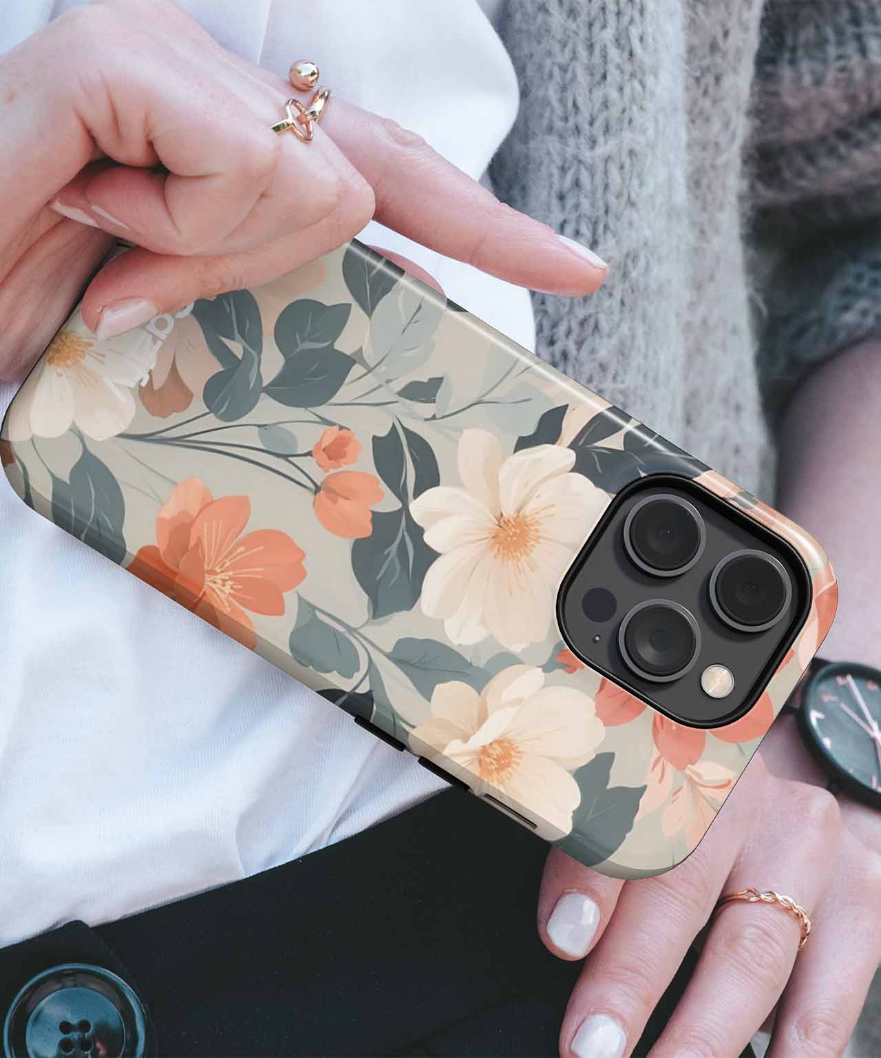 Floral patterned iPhone case with beige, orange, and green tones on black background. - Blooming Floral Delight in Soft Pastels iPhone case - Cazify Canada