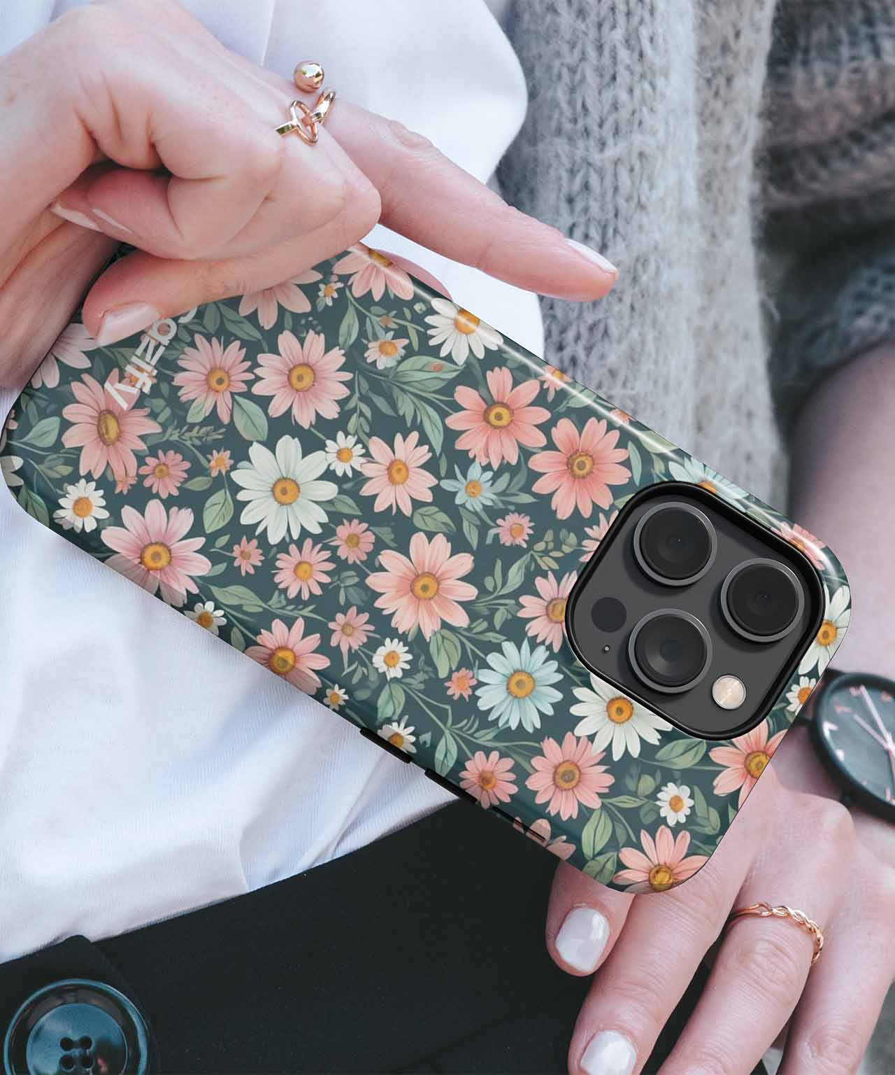 Floral pattern iPhone case with green background and pink and white daisies on iPhone Pro Max. - Brightly Blooming Floral Wonderland iPhone case - Cazify Canada