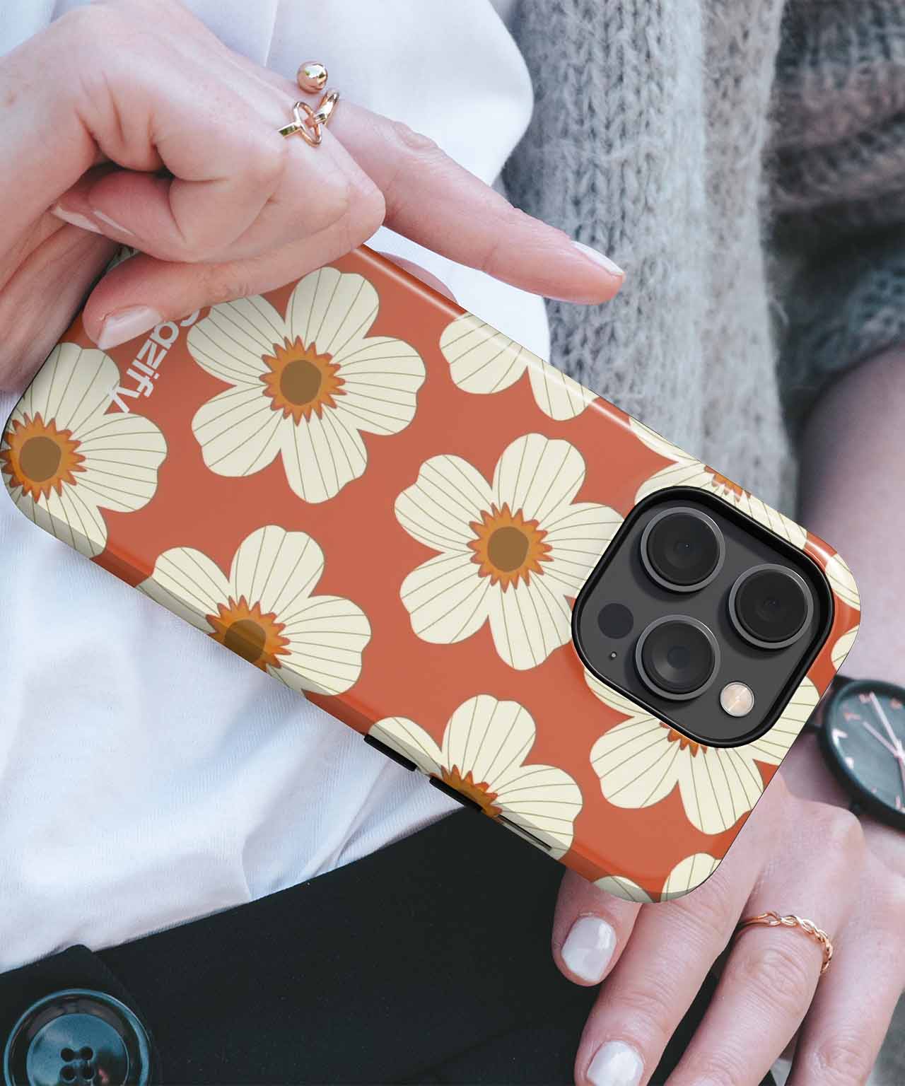 Orange iPhone case with large white daisy flowers and brown centers. - Cazify Canada - Charming Floral Fiesta on Terracotta iPhone case