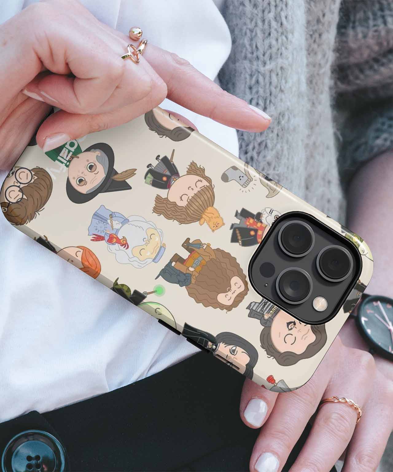 Beige phone case with colorful illustrated diverse faces and characters pattern, fitted on black iPhone with triple camera. - Cazify Canada