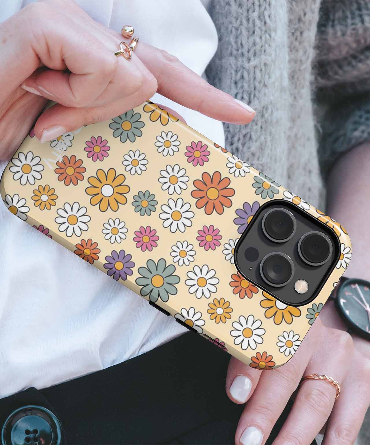 Yellow phone case with multicolored daisy flowers and black camera cutout edges. - Cazify Canada