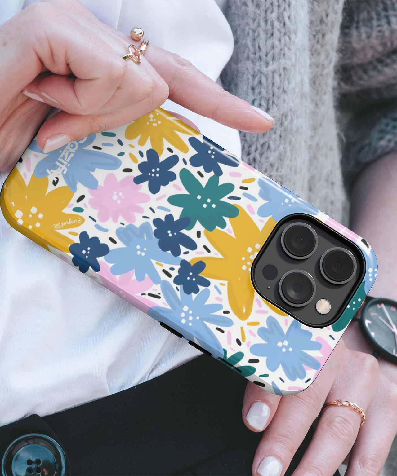 Phone case with colorful blue, yellow, pink, and green floral pattern on white background. - Cazify Canada