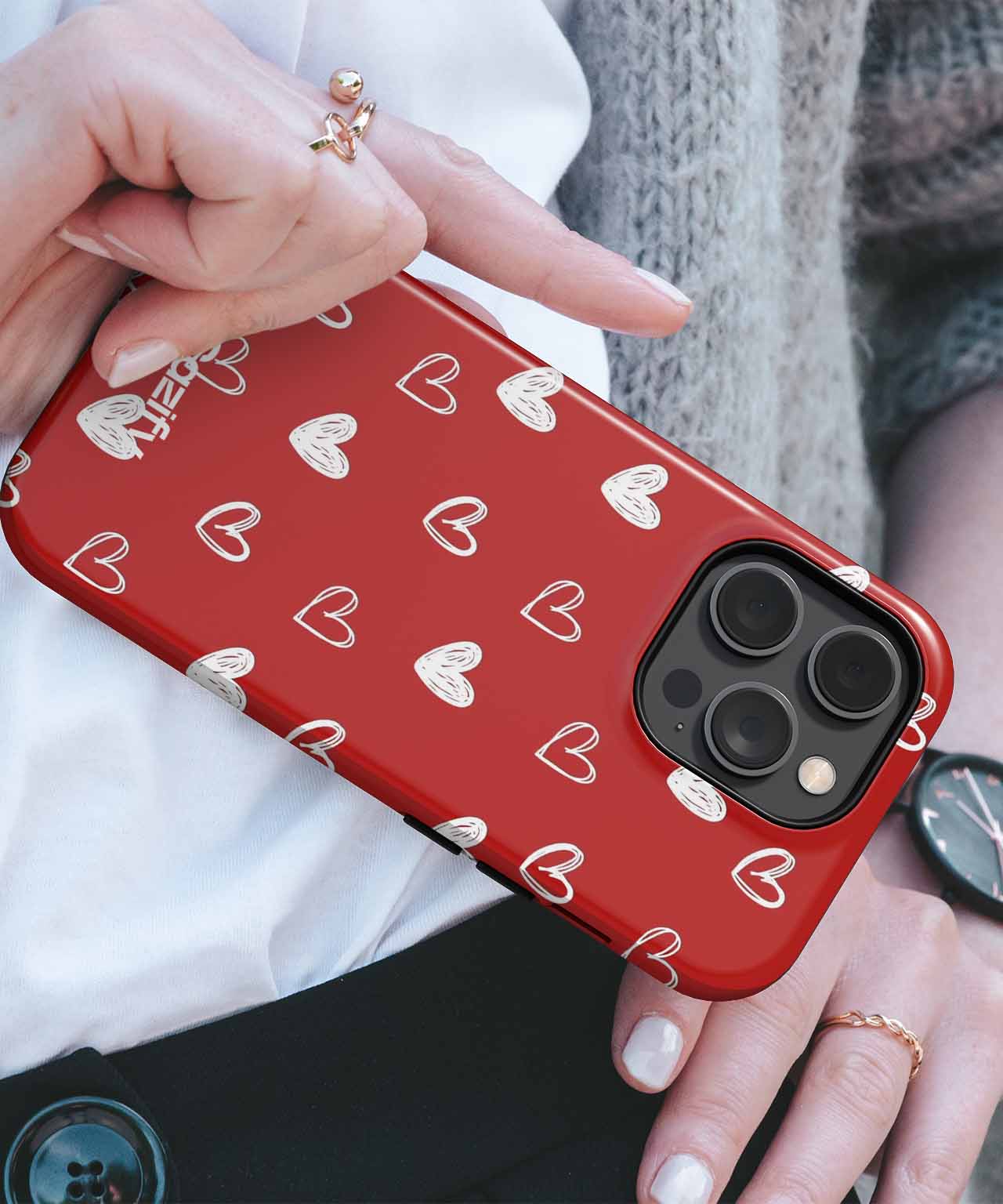 Red iPhone case with white heart pattern and black camera cutout. - Cazify Canada