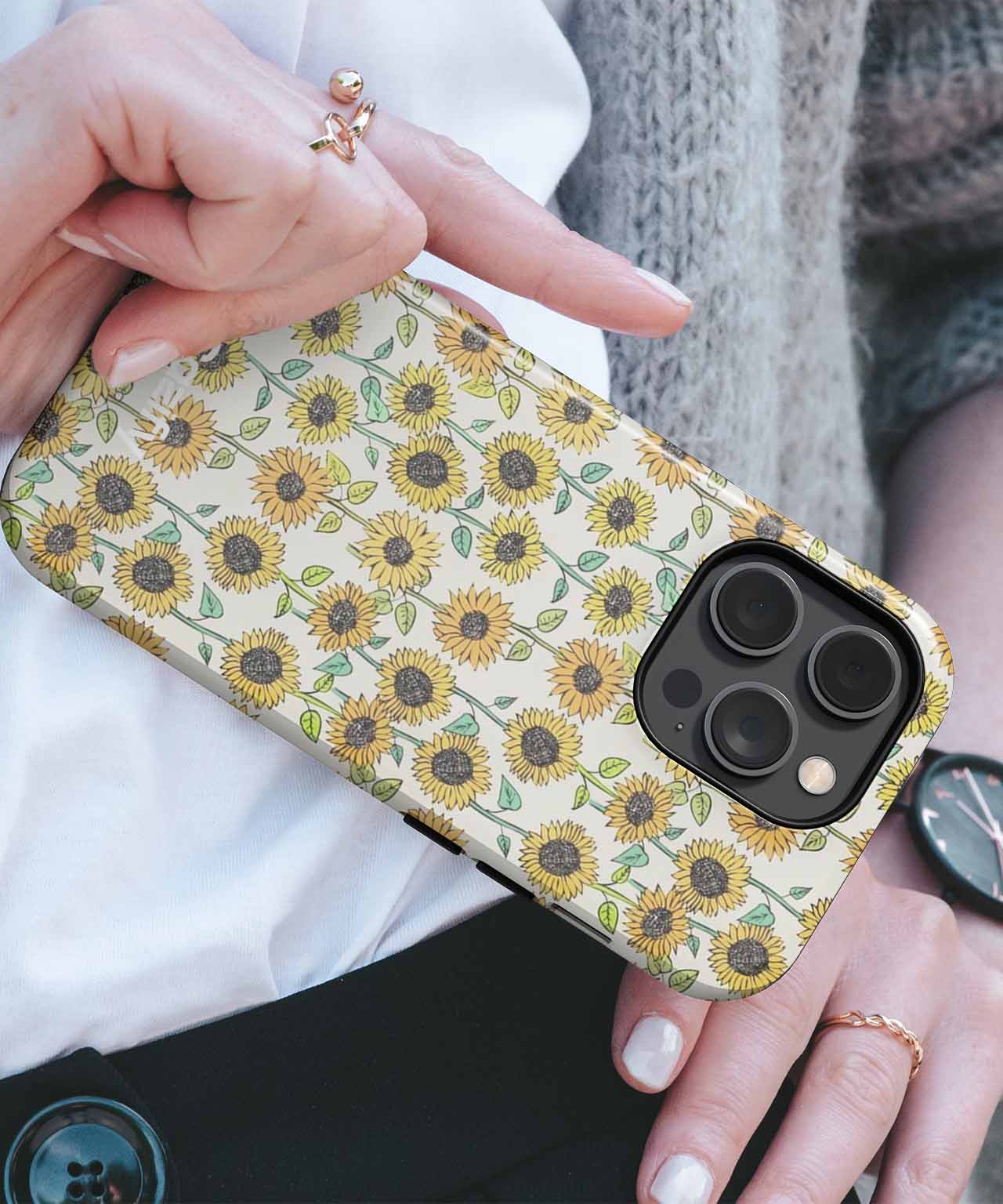 Yellow sunflower pattern phone case on black iPhone with triple camera cutout. - Cazify Canada