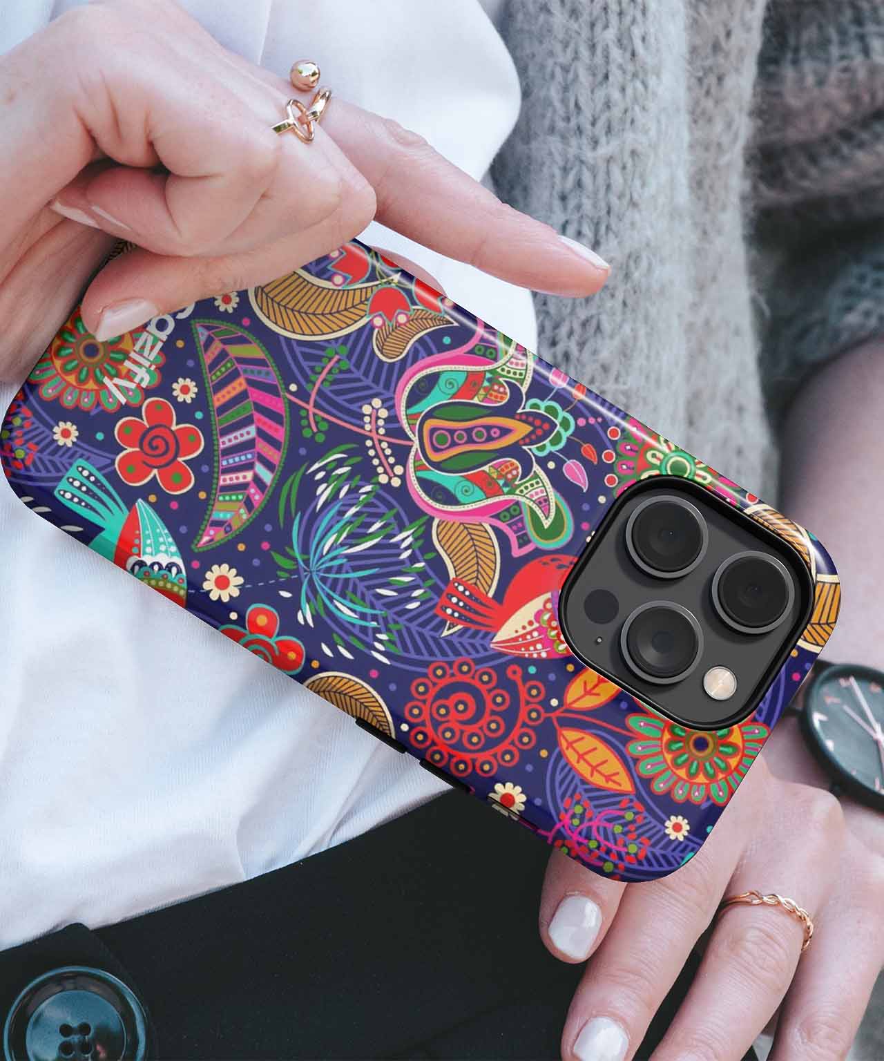 Colorful patterned phone case with floral and abstract designs on black iPhone Pro model. - Cazify Canada