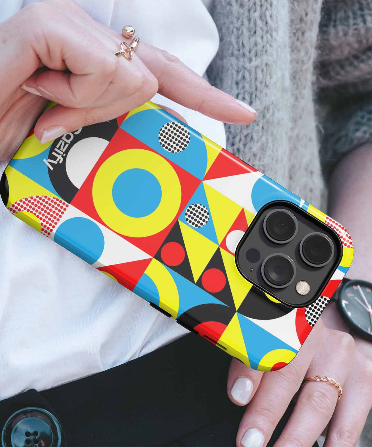 Colorful geometric patterned phone case on black iPhone with triple camera lenses. - Cazify Canada