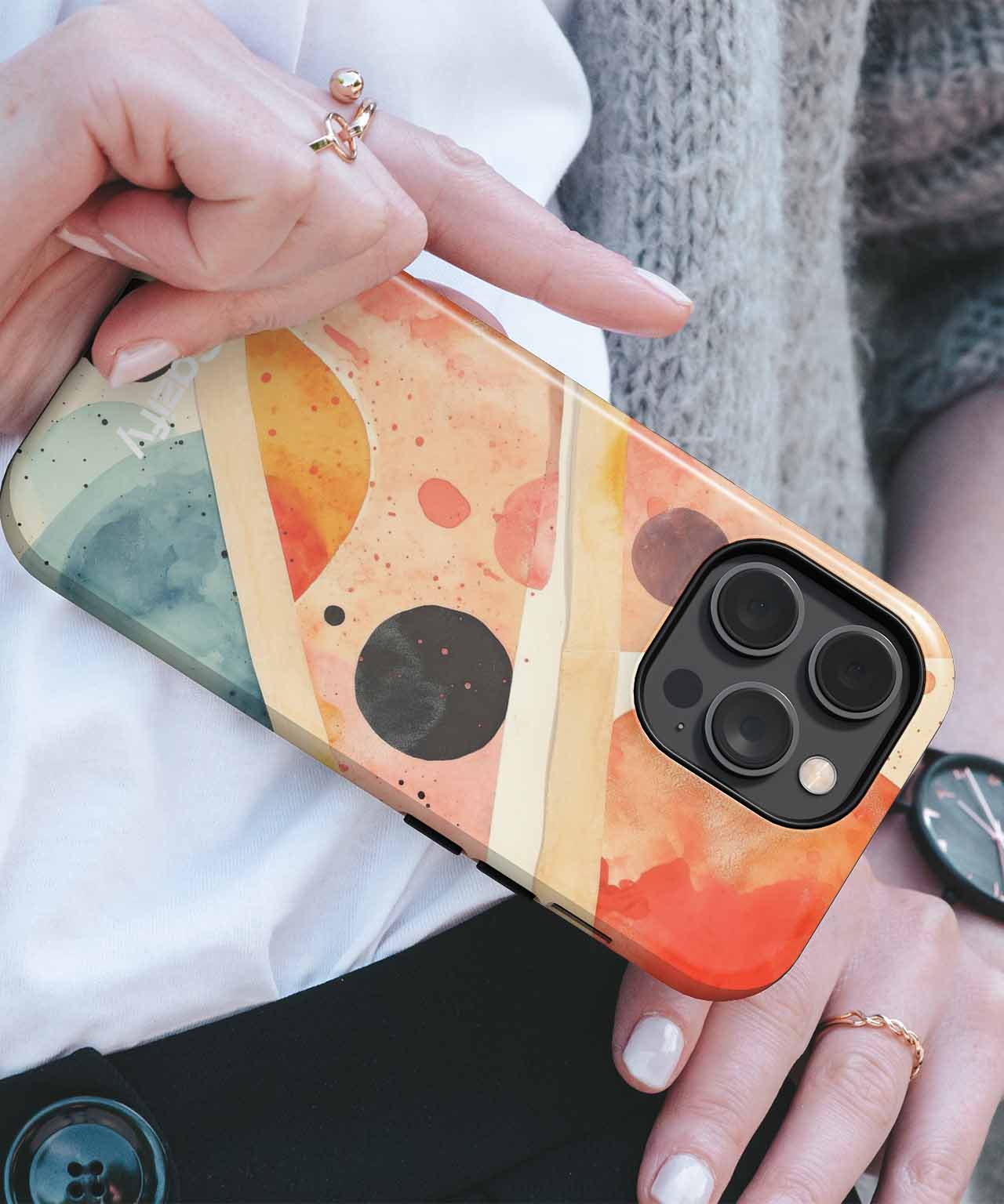 Colorful abstract geometric iPhone case with orange, beige, and green tones on a gold-edged phone. - Cazify Canada