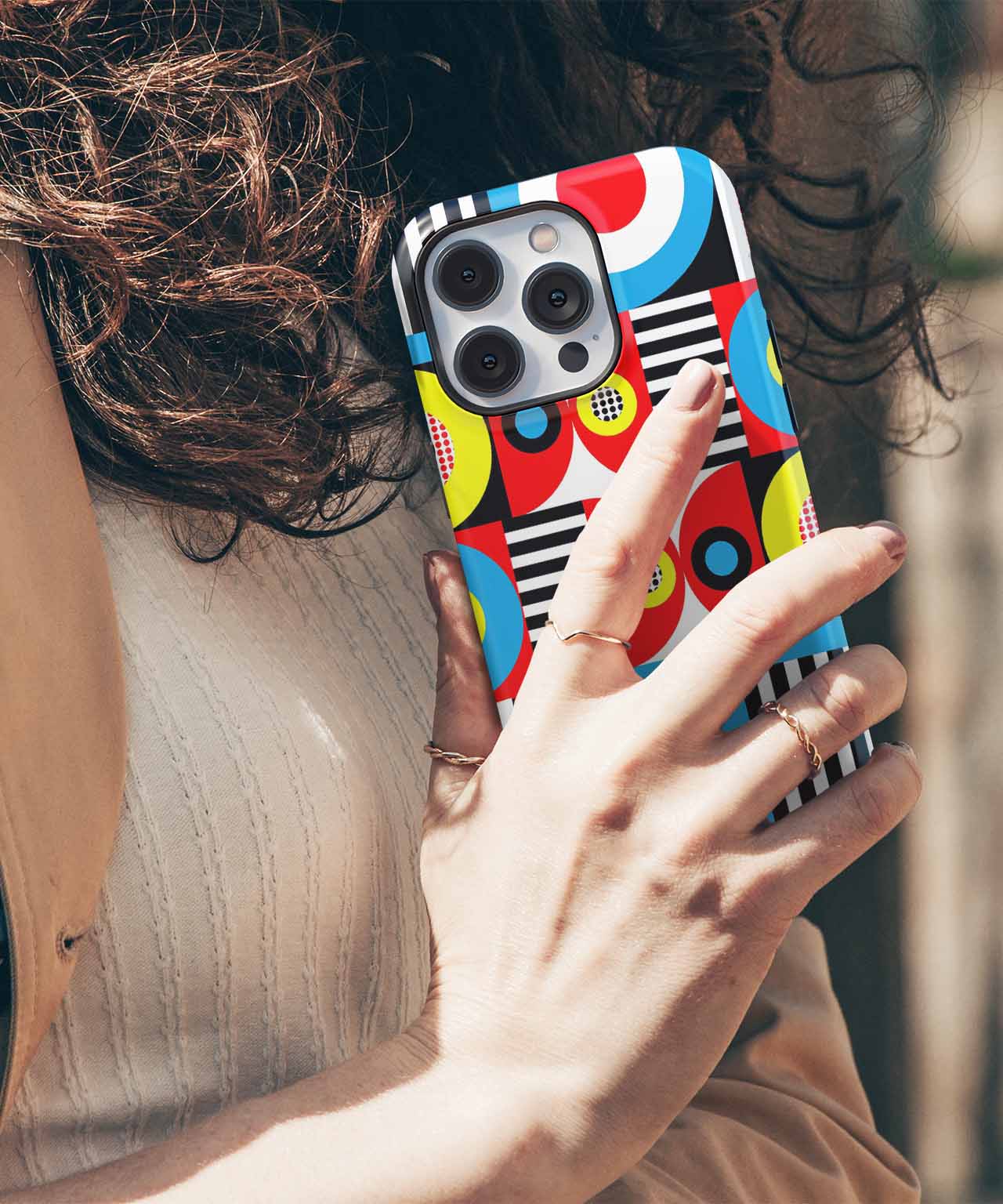 Colorful abstract patterned phone case on a gold iPhone with triple cameras. - Cazify Canada