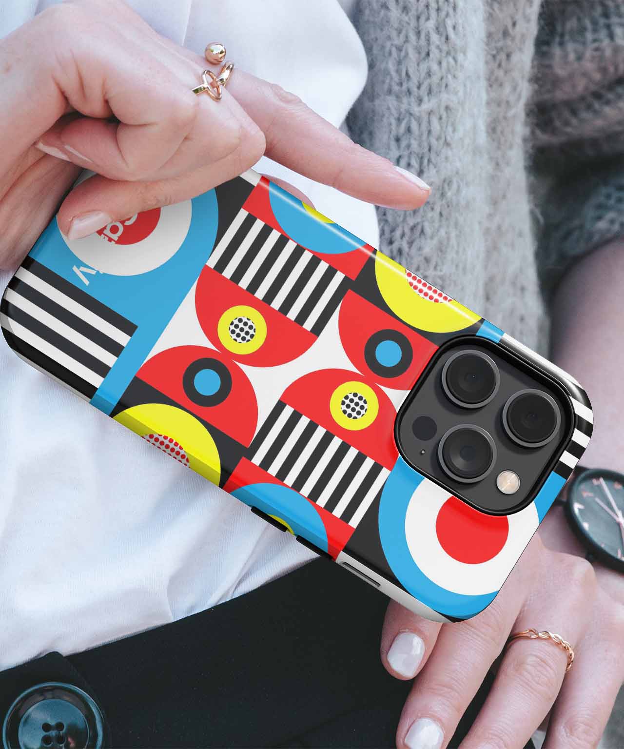 Colorful geometric patterned phone case on an iPhone held in hand. - Cazify Canada
