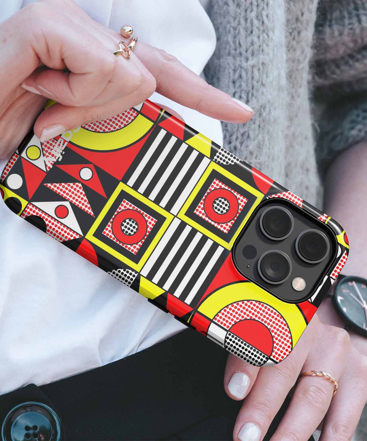 Colorful geometric pattern phone case with red, yellow, black, and white shapes on an iPhone. - Cazify Canada