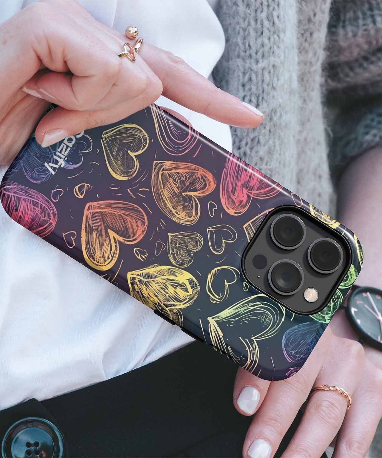 Black iPhone case with colorful sketch-style heart designs and gold zipper closure. - Cazify Canada