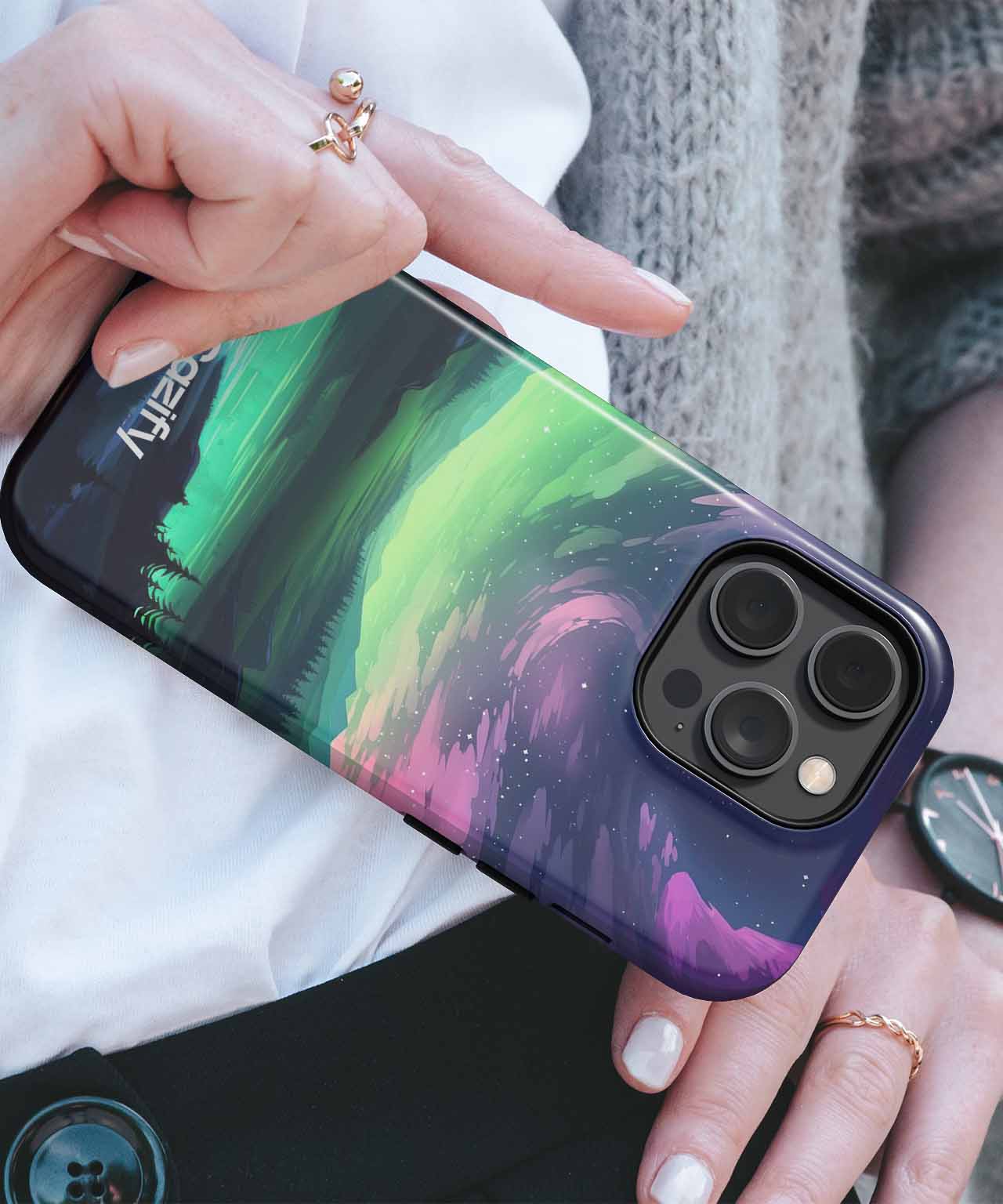 Cazify Canada - Purple and green galaxy-style phone case on a black iPhone with triple camera lenses.