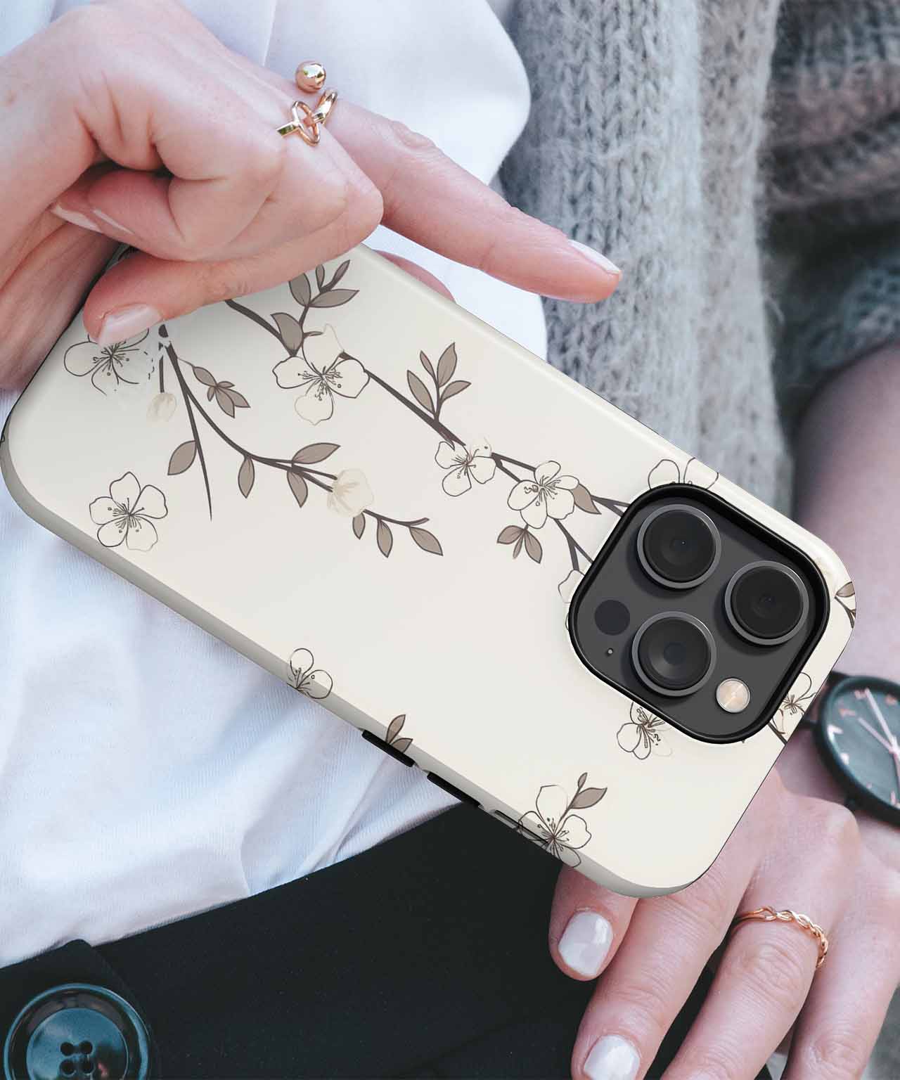 Clear iPhone case with delicate brown floral branch design on a gold background. - Cazify Canada