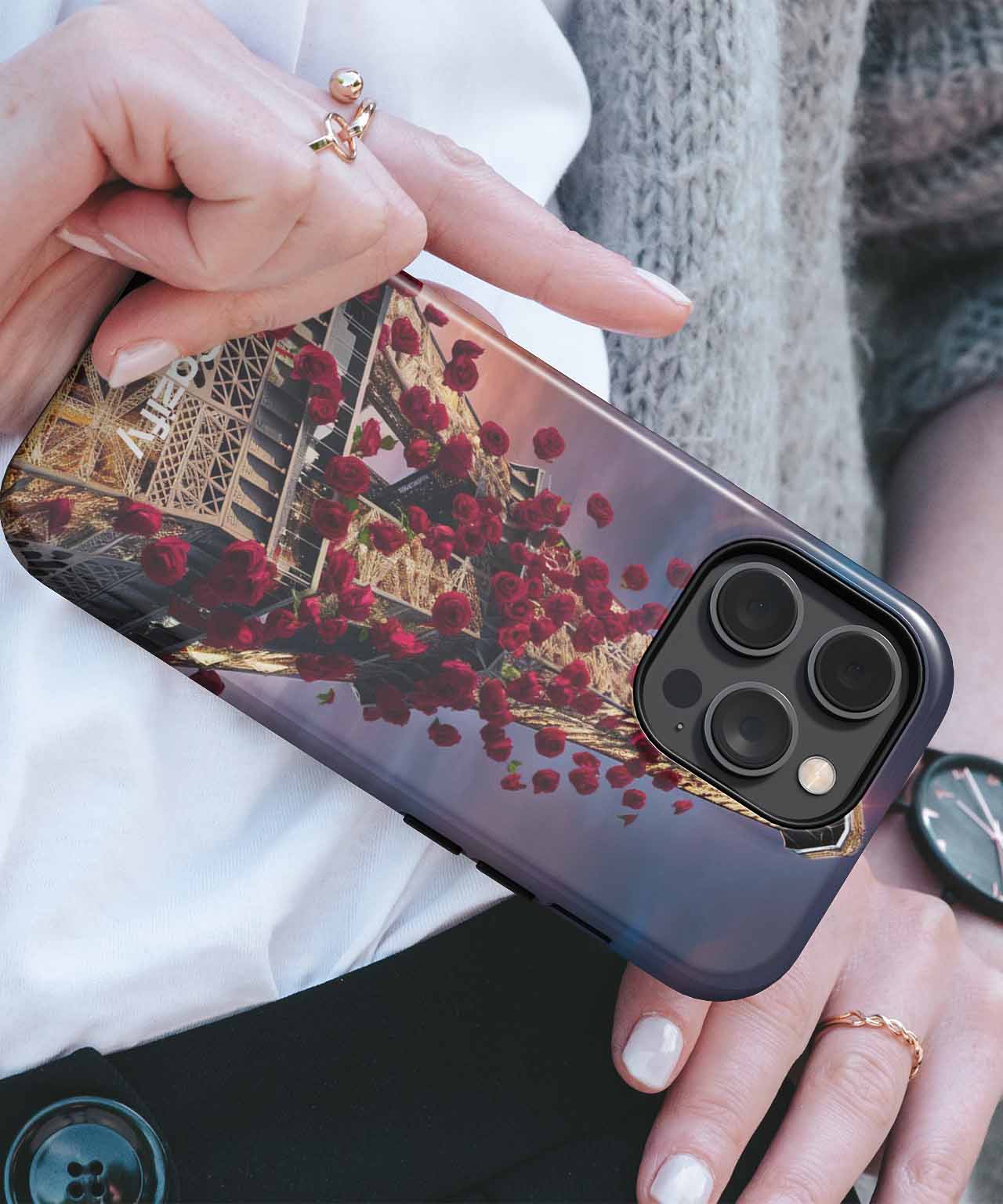 Glossy black iPhone case with red rose pattern and reflective surface on gold phone. - Cazify Canada