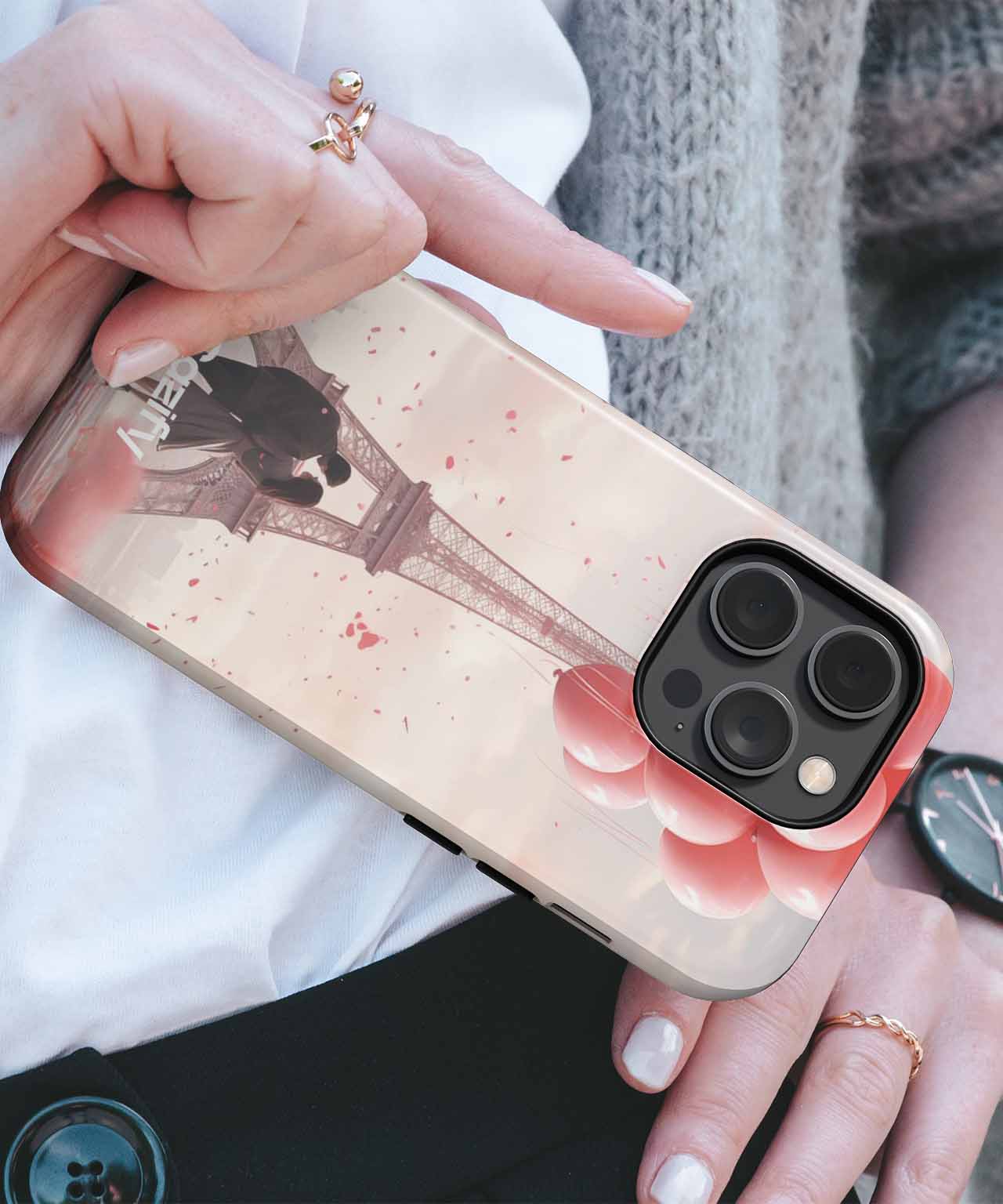 Clear iPhone case with vintage Eiffel Tower print and rose gold camera border on black smartphone. - Cazify Canada