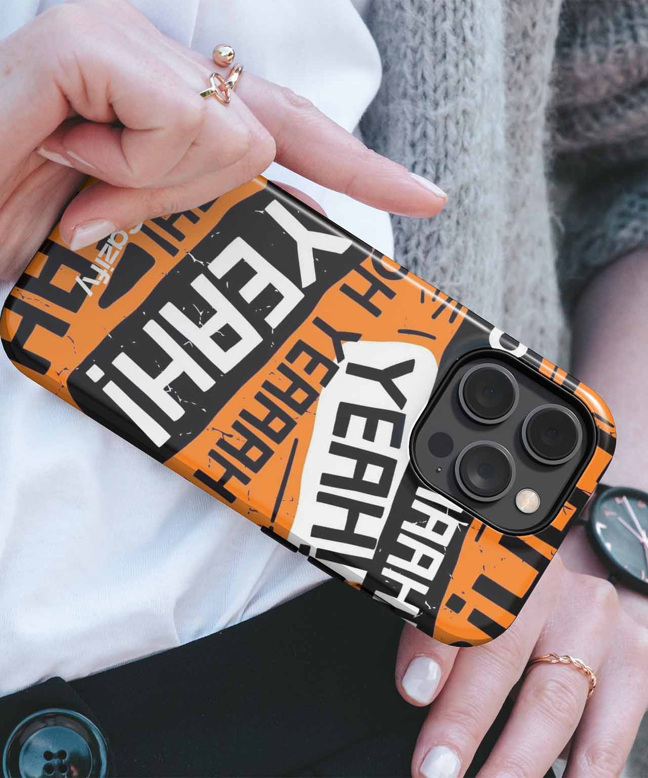 Black iPhone case with bold orange, white, and black "YEAH" graphic text design. - Cazify Canada