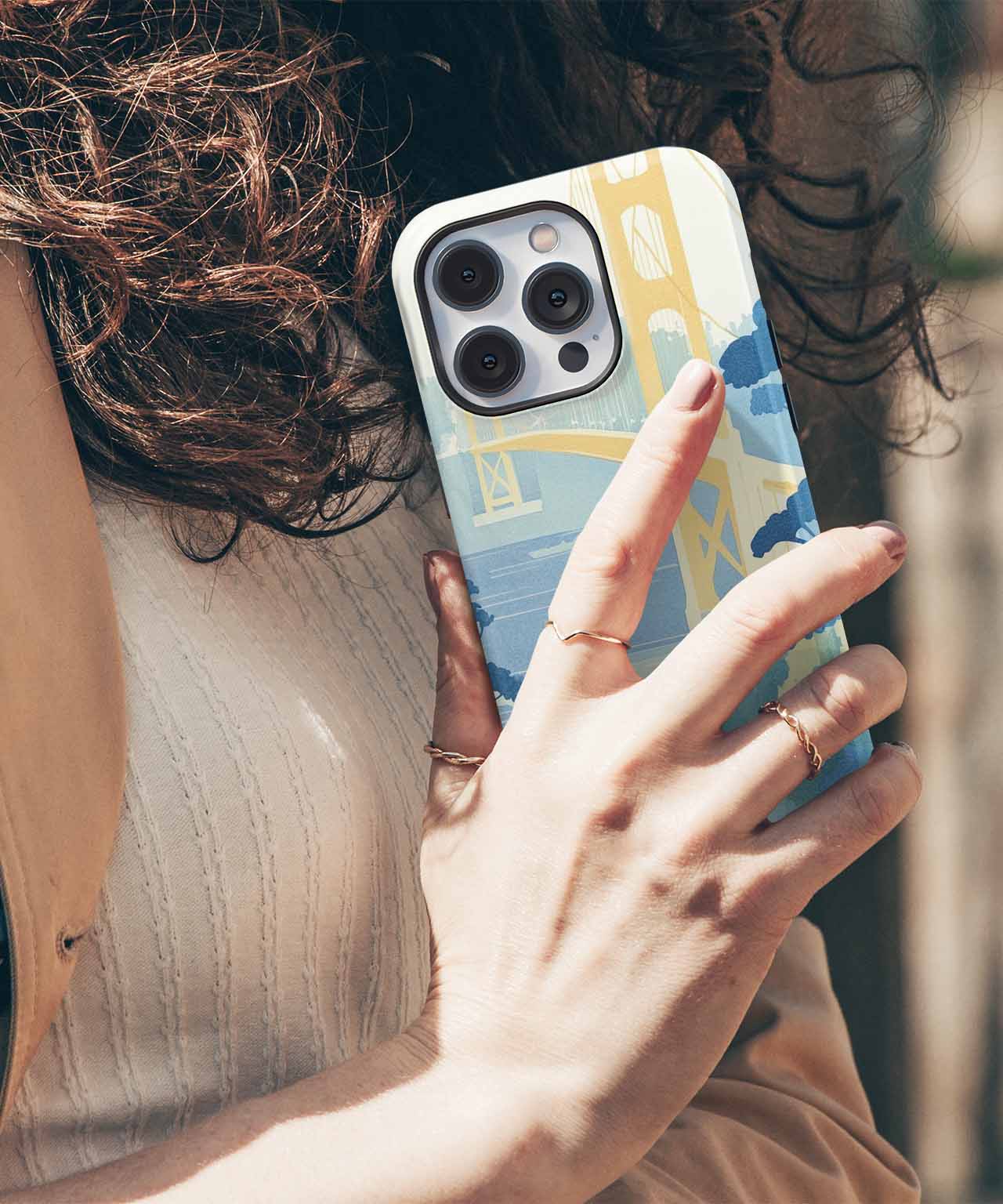 Cazify Canada - IPhone with a colorful camera lens protective case featuring blue, yellow, and beige blocks.