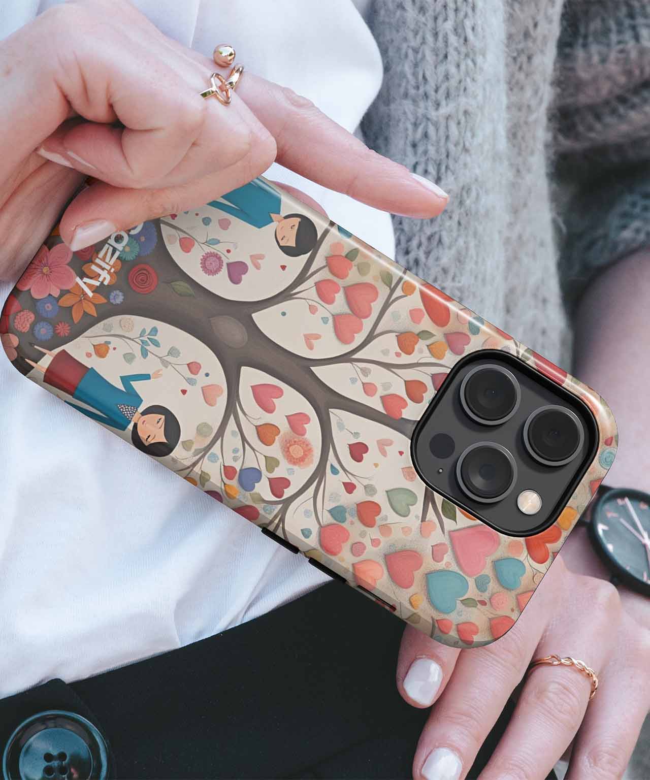 Colorful tree and heart pattern on soft beige iPhone case with black camera cutout. - Cazify Canada