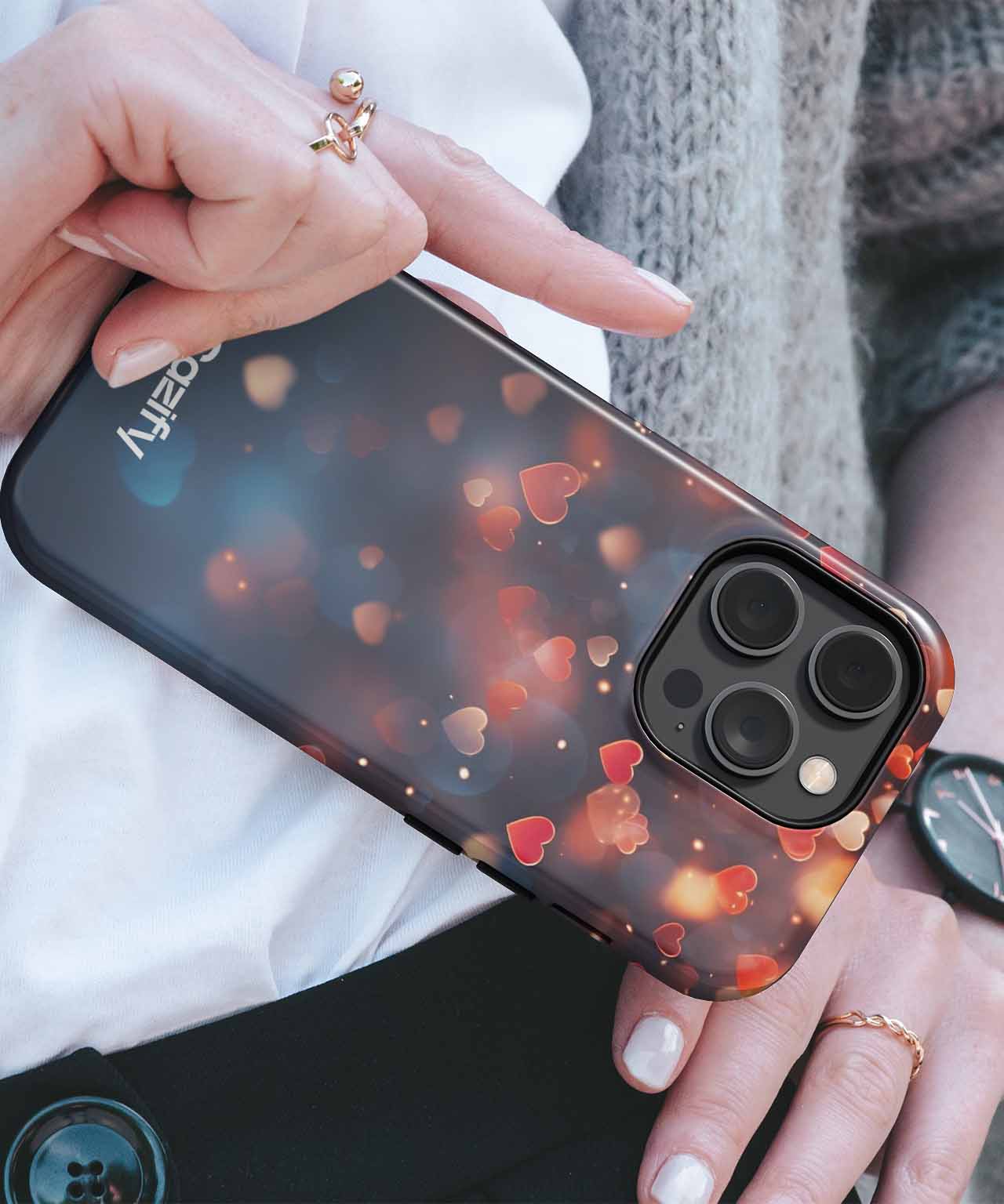 Black iPhone case with red heart-shaped confetti design and wide camera cutout. - Cazify Canada