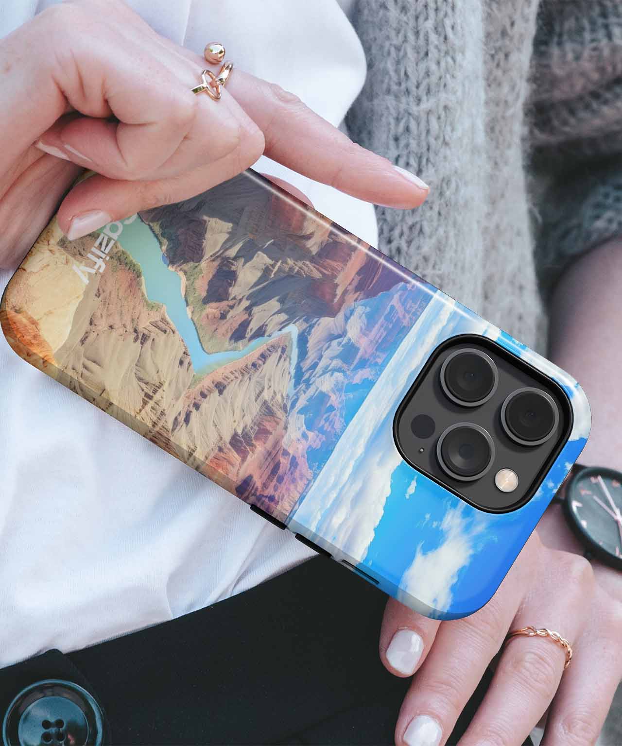Cazify Canada - Colorful mountain and sky design clear phone case on black iPhone with triple camera lenses.