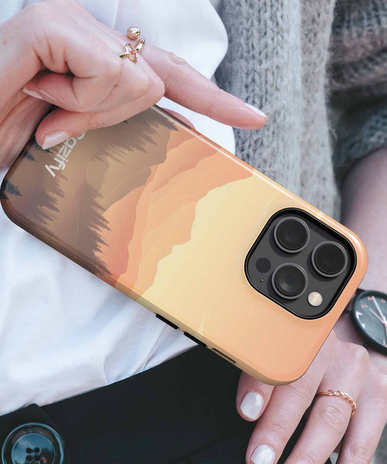 Cazify Canada - Gradient mountain landscape phone case in warm tones on gold iPhone with triple camera.
