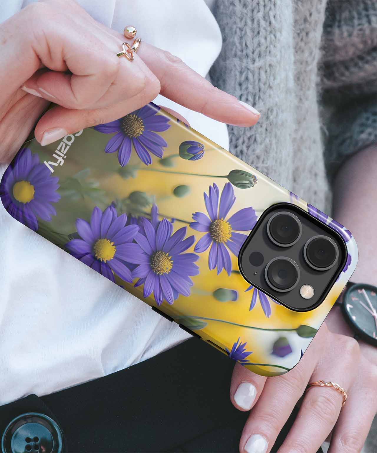 Transparent iPhone case with purple daisies and green stems over yellow background. - Purple Daisy Delight in a Sunny Field iPhone case - Cazify Canada