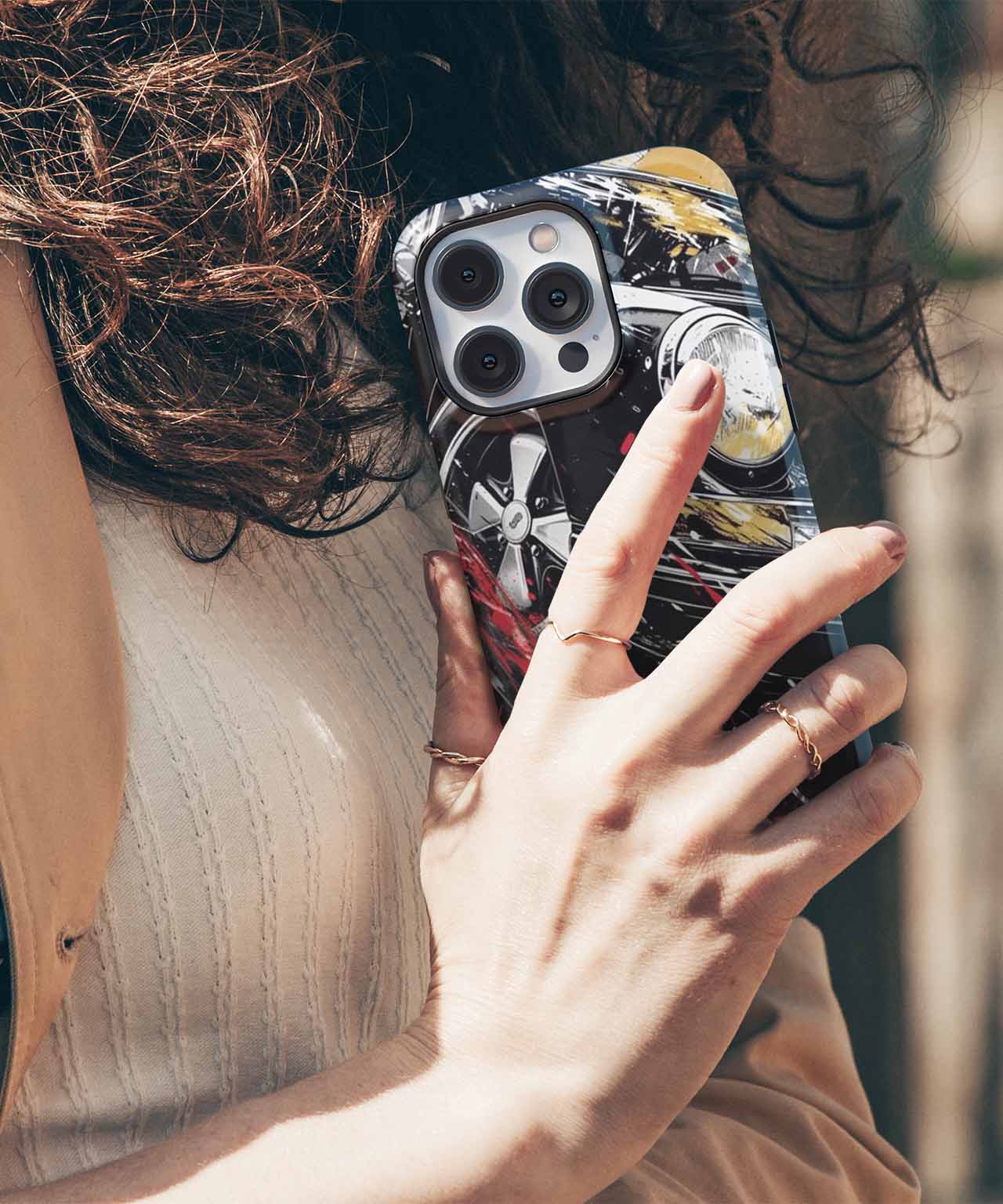 Glossy black phone case with abstract white and yellow design on iPhone with triple camera lenses. - Cazify Canada