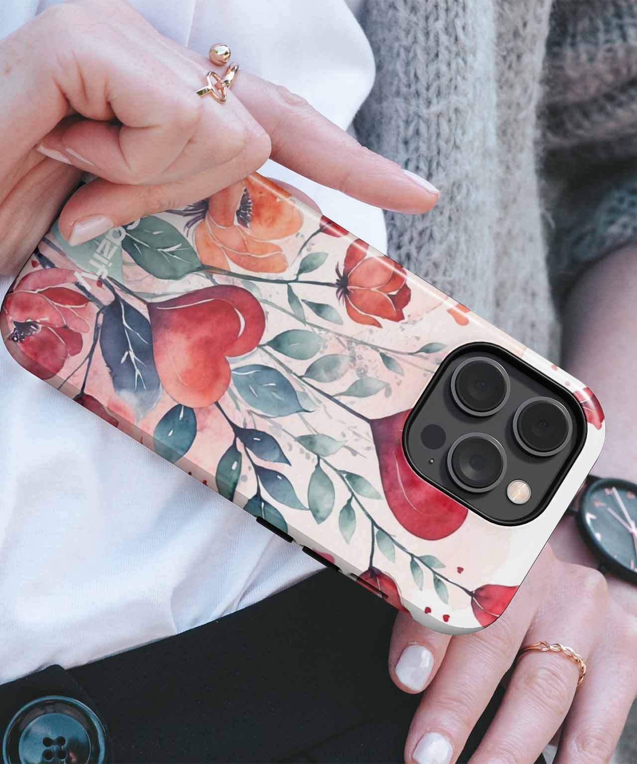Cazify Canada - Floral iPhone case with red and orange flower design held in hand.