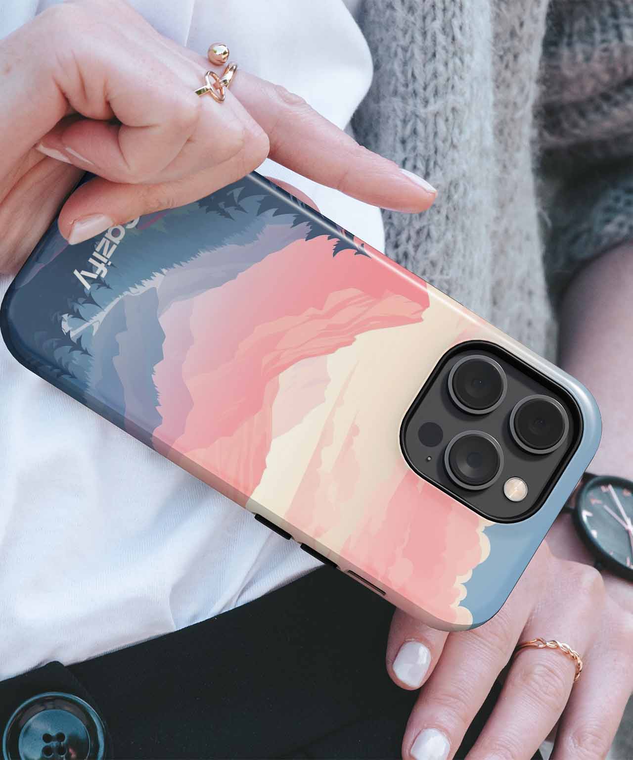 Cazify Canada - Matte phone case with layered pastel mountain design on a blue background, fitted on a black iPhone model.