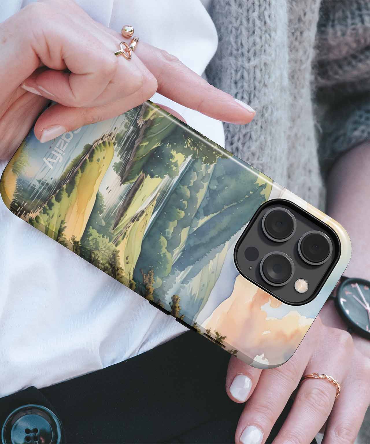 IPhone with green and yellow forest-themed case and black triple camera lenses. - Cazify Canada