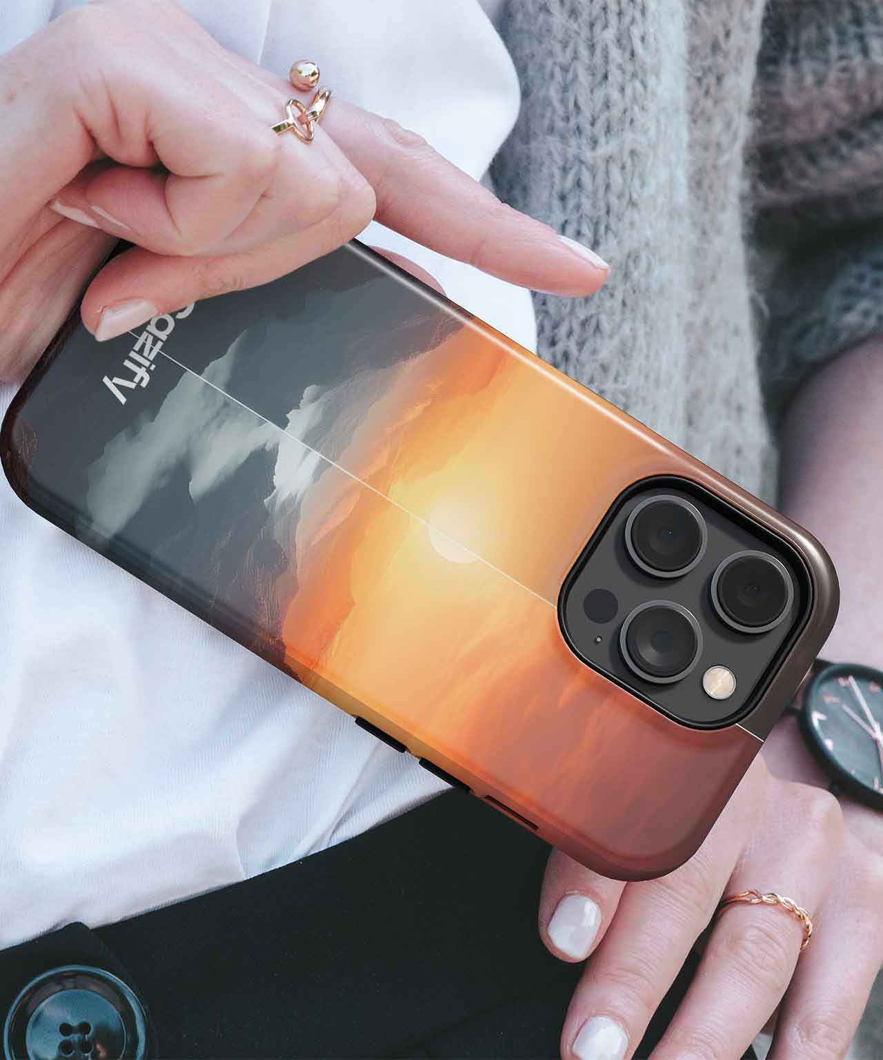 Cazify Canada - Black iPhone case with sunset and flying bird design, held in hand.