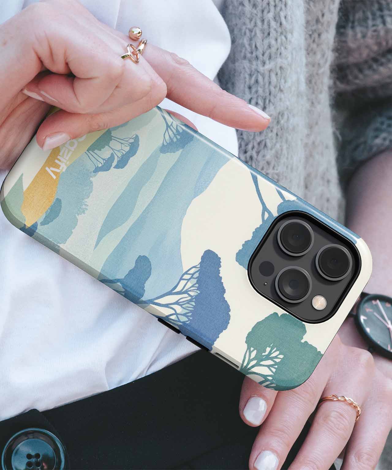 Cazify Canada - Phone case with abstract blue and beige nature-inspired pattern on an iPhone with triple camera lenses.