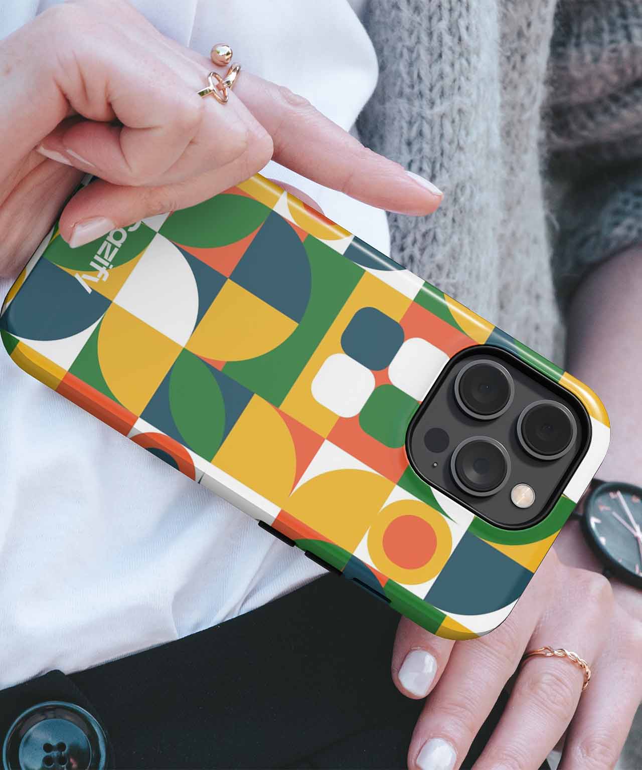 IPhone with colorful geometric pattern case featuring green, yellow, white, and orange shapes. - Cazify Canada