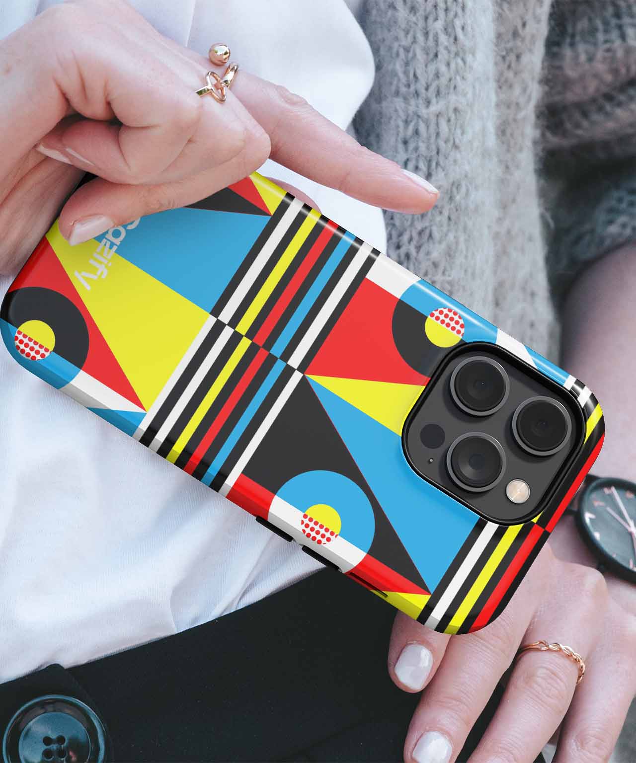 Colorful geometric patterned iPhone case with bold stripes and shapes on a black background. - Cazify Canada