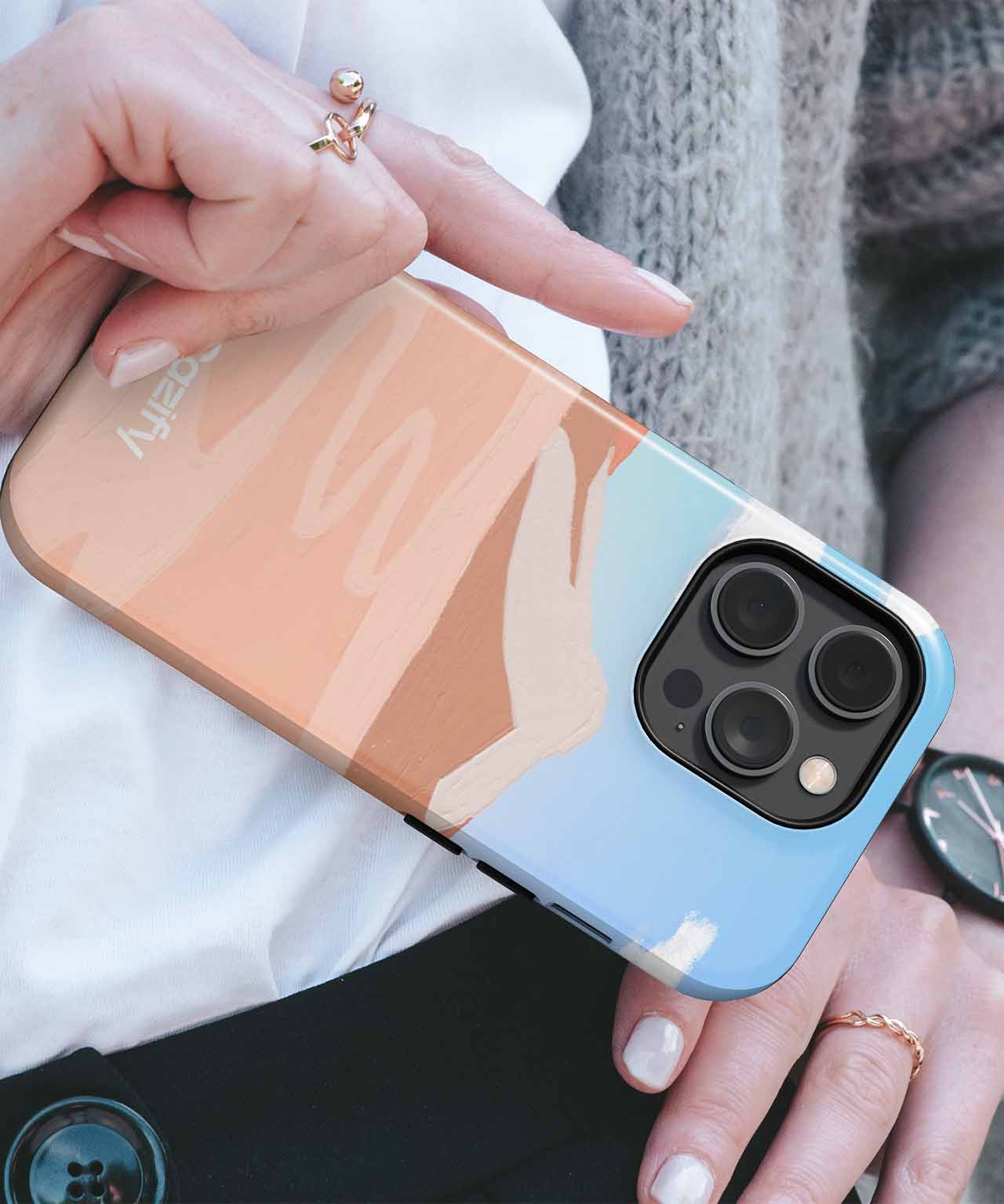 Cazify Canada - IPhone with abstract pastel blue, peach, and beige color block case and triple camera lenses.
