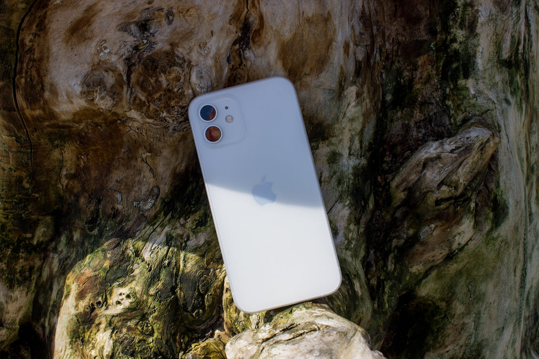 a white iphone sitting on top of a rock