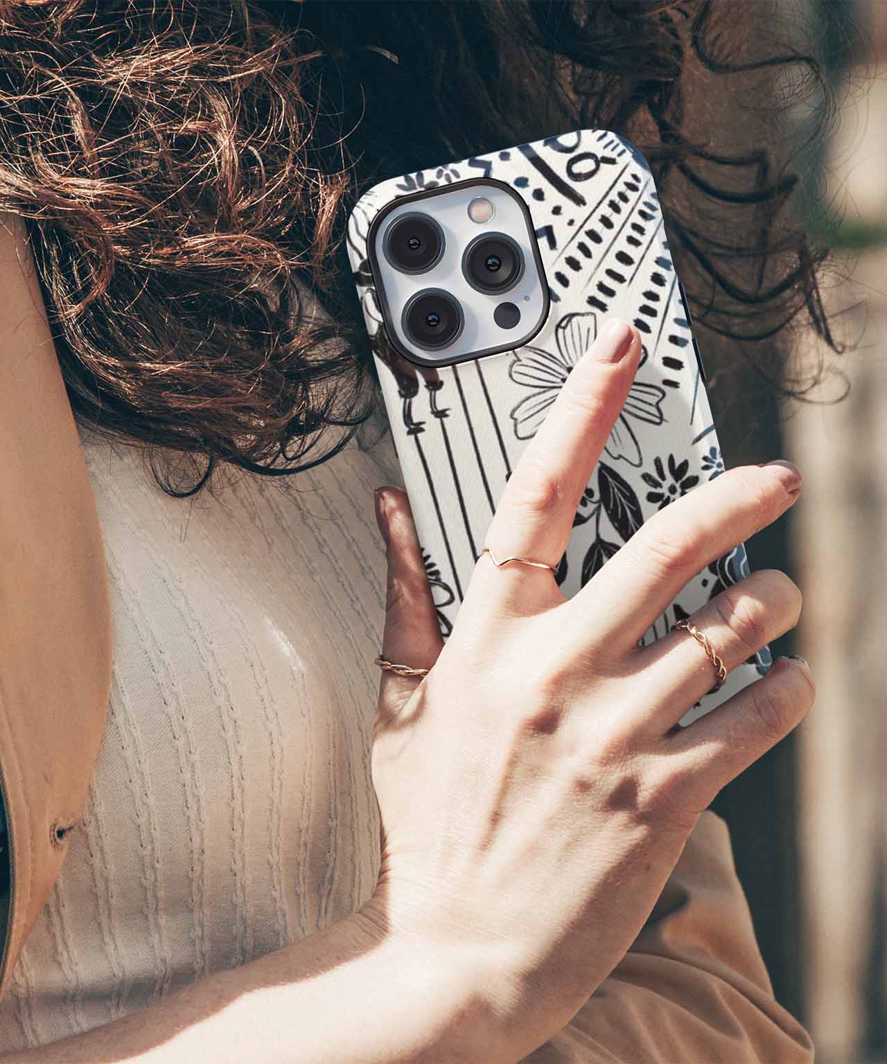 Black and white abstract patterned phone case on a smartphone with triple camera lens. - Cazify Canada