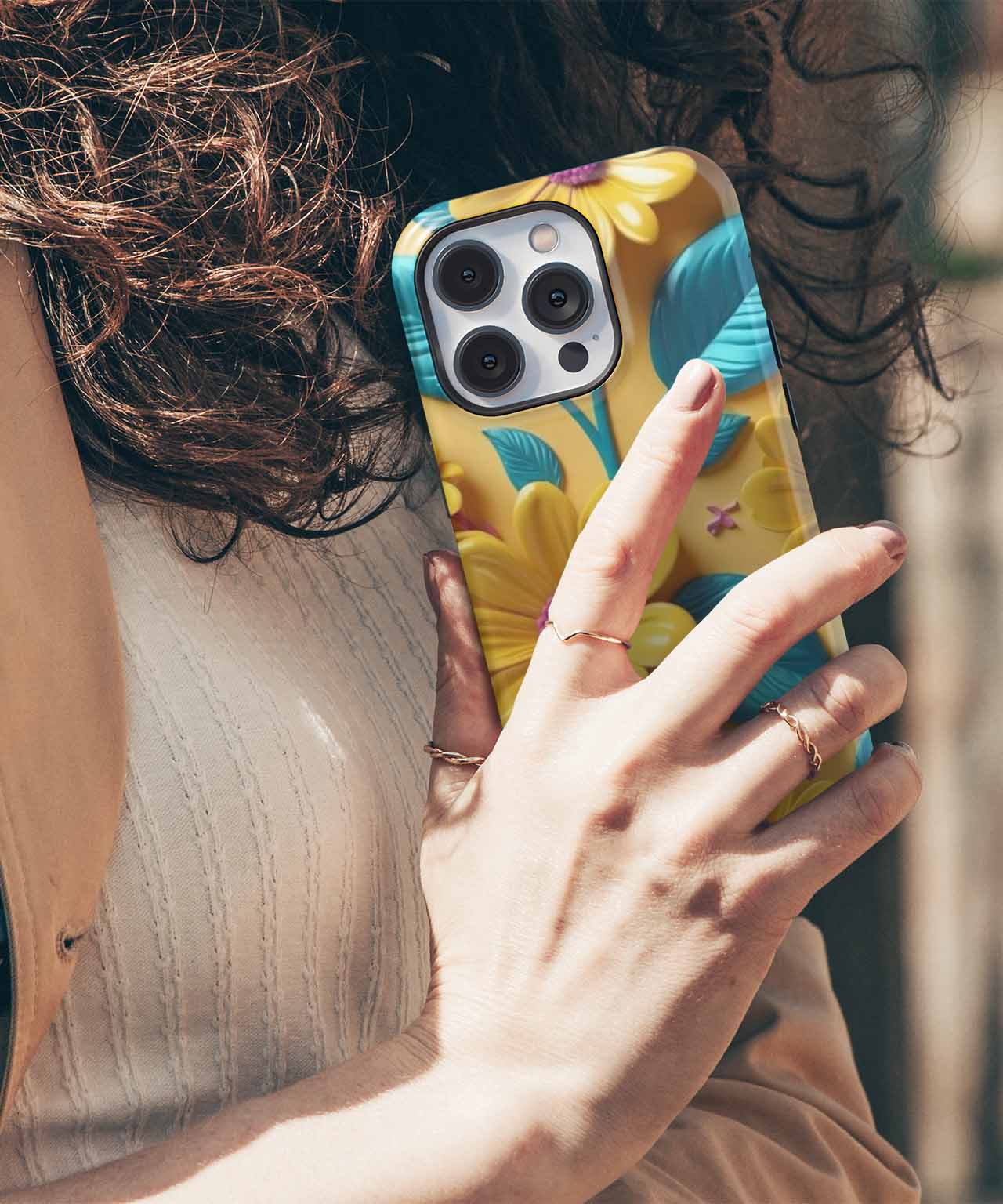 Colorful floral phone case with yellow and blue petals on a large smartphone with triple cameras. - Cazify Canada