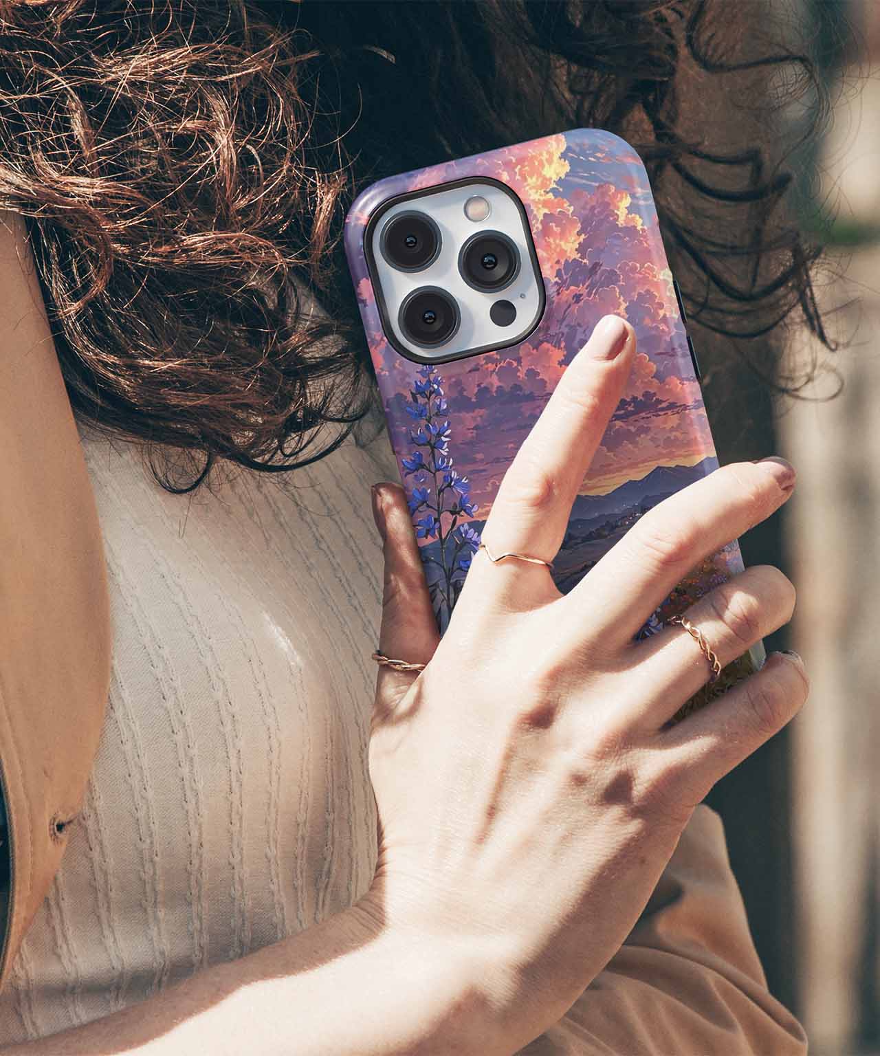 Cazify Canada - Purple and orange marbled iPhone case with triple camera cutout on hand-held smartphone.